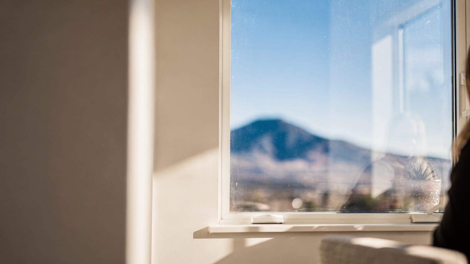 A spotless window framing the Front Range foothills and clear Colorado sky